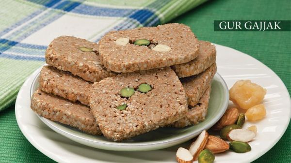 This may contain: some cookies and nuts on a plate with a green table cloth in the back ground