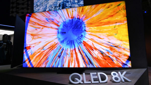 A QLED 8K TV in a store with a brightly-colored display screen