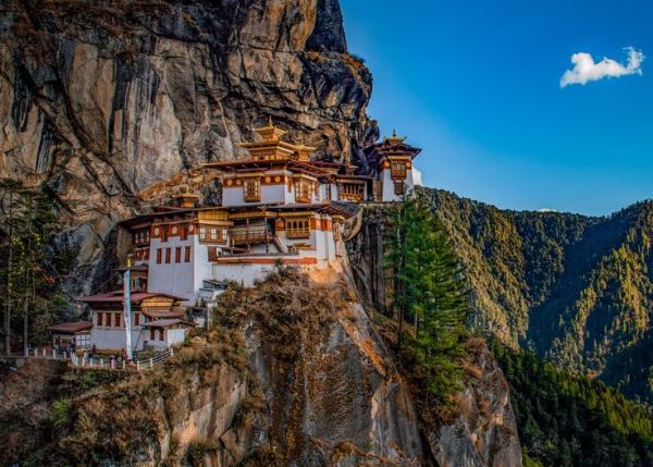 This may contain: a mountain with some buildings on top of it