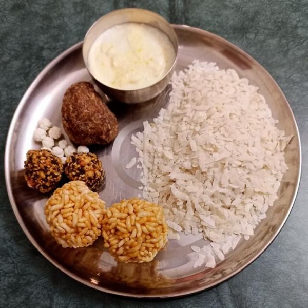 This may contain: a metal plate topped with rice and other foods