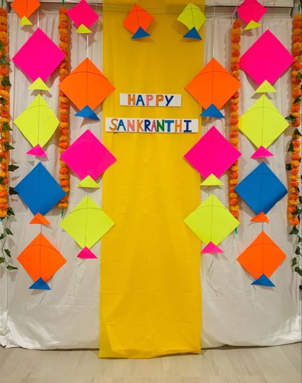 This may contain: colorful paper decorations are on display in front of a yellow backdrop that says happy sankish