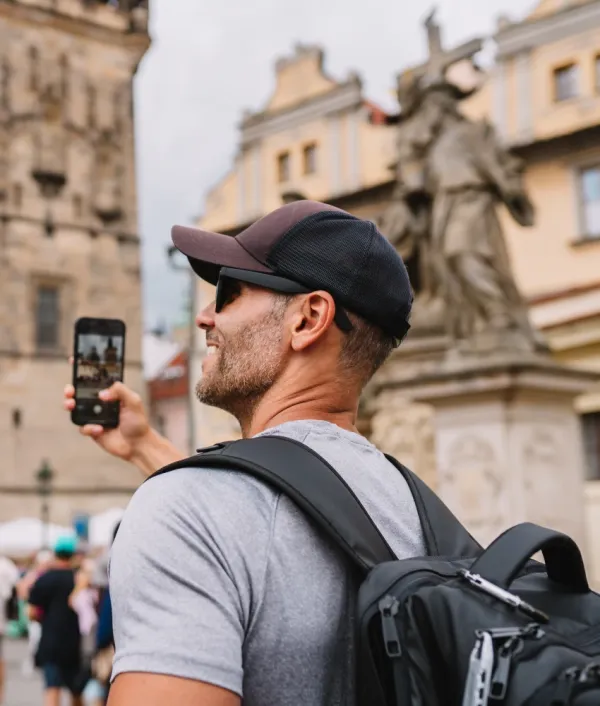 tourist man wearing baseball cap in Europe