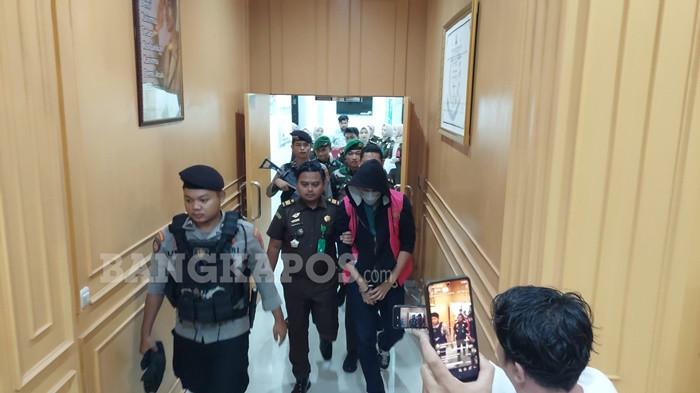 DIGIRING PETUGAS -- Aditya Rizki Pradana tampak digiring keluar dari Gedung Kejaksaan Negeri Bangka Selatan dengan pengawalan ketat petugas, Rabu (14/1/2026) malam. Aditya Rizki Pradana resmi ditetapkan sebagai tersangka tindak pidana korupsi SP3AT fiktif.