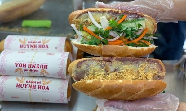 A loaf of banh mi is filled with cucumber, pickles and salted shredded pork on top of pate and butter served at a stall in HCMC. Photo by VnExpress/Quynh Tran