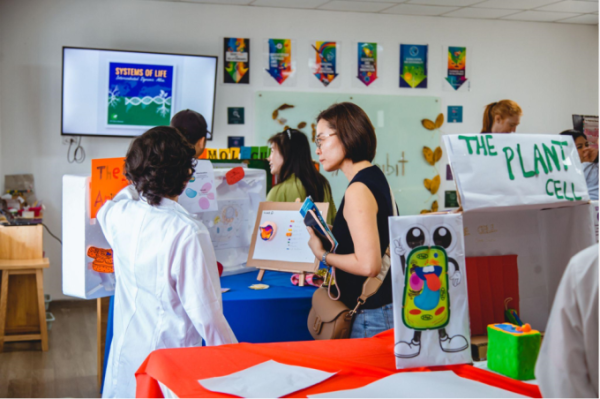 Students experiencing Odyssey Secondary Science Exhibition about Systems of Life. Photo courtesy of Odyssey International School