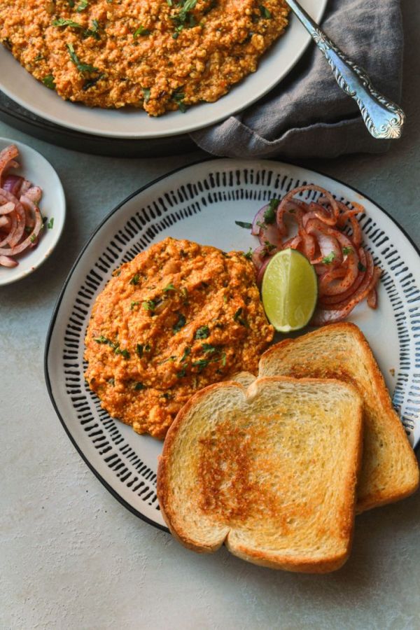 This may contain: two plates with toast, meat and vegetables on them next to a bowl of soup