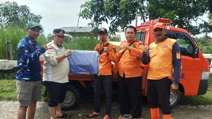 TANGGUL JEBOL: Badan Penanggulangan Bencana Daerah (BPBD) Kabupaten Bekasi saat meninjau lokasi tanggul jebol Sungai Citarum Desa Pantai Bakti, Kecamatan Muara Gembong, Kabupaten Bekasi pada Selasa (20/1/2026).