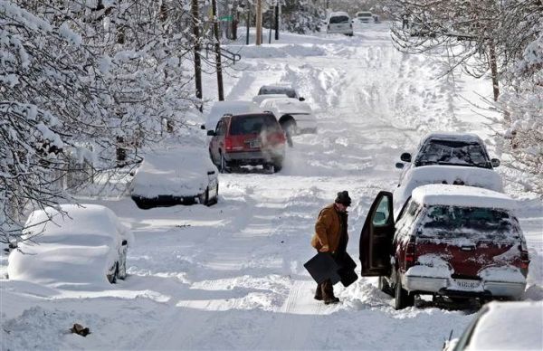 This may contain: cars are parked on the side of a snow covered road as people look at them