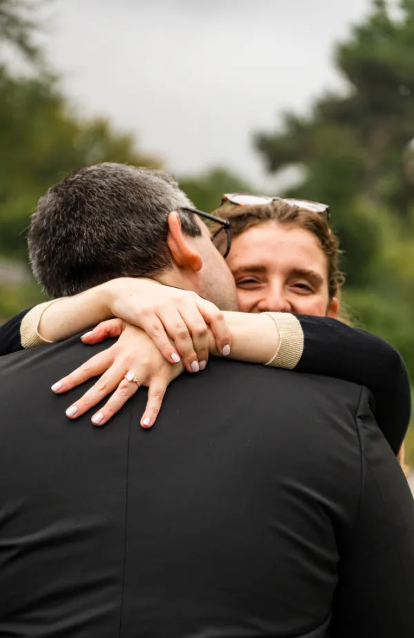 Michelle Bernstein embracing Jamie Evan Bichelman, showing off her lab-grown diamond engagement ring.
