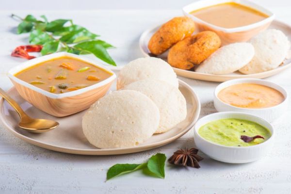 This may contain: three plates with different types of food on them, including breads and soups