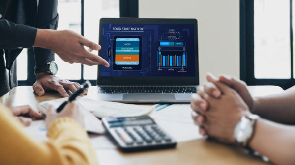 hand pointing to laptop screen showing info about solid state battery construction