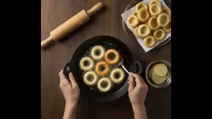 Round canapes being deep fried in hot oil until golden brown and crispy.
