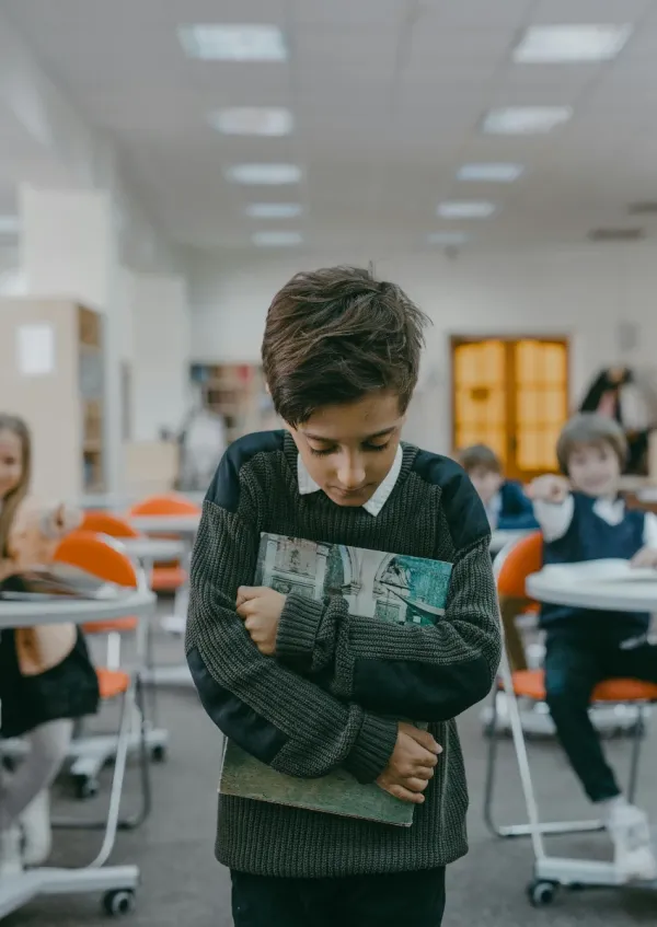 boy being bullied by classmates at school