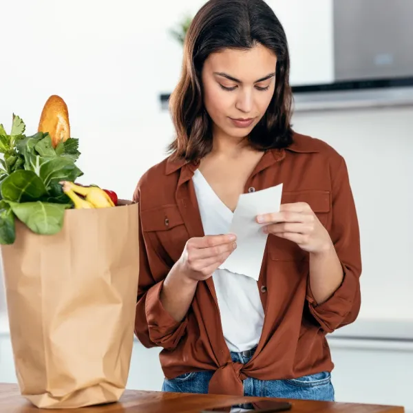 woman checking her receipt after getting Uber Eats delivery 