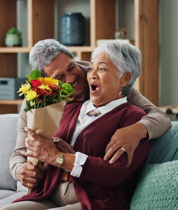 man surprising wife with flower bouquet that's not from the grocery store