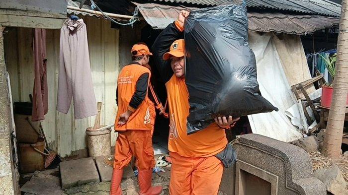 Petugas PPSU saat membantu pemindahan barang-barang warga TPU Kebon Nanas ke Rusun, Jatinegara, Jakarta Timur, Selasa (6/1/2026).