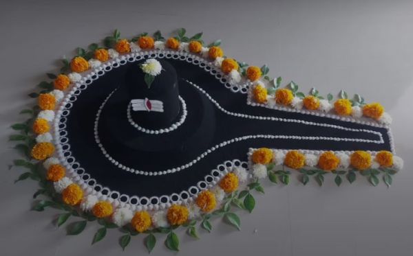 This may contain: a black hat with white and yellow flowers on it is hanging from the wall next to a green leafy plant