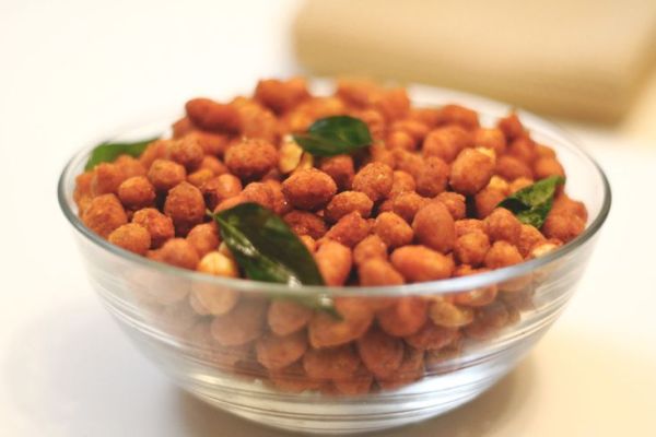 This may contain: a glass bowl filled with chickpeas and spinach