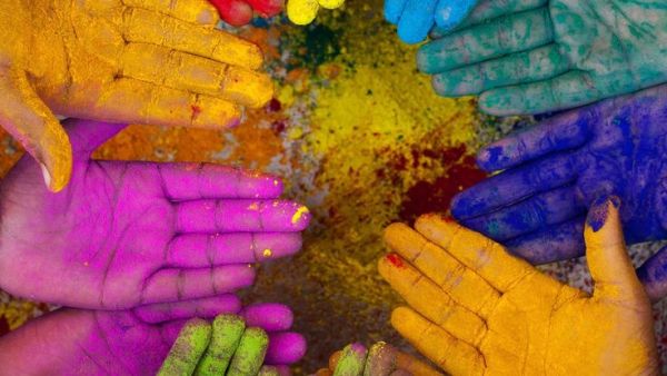 This may contain: many hands are covered in colored powder