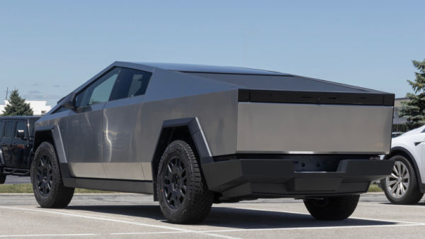 Rear 3/4 view of Tesla Cybertruck in parking lot