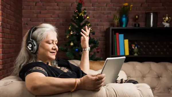 woman listing to music sitting on sofa