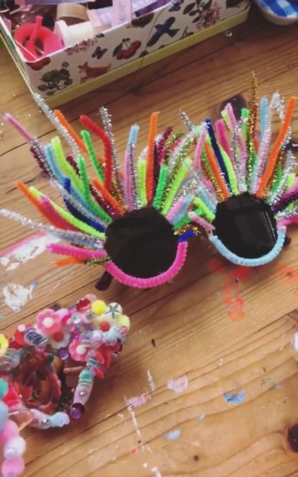 This may contain: a pair of colorful eye glasses sitting on top of a wooden table next to candy