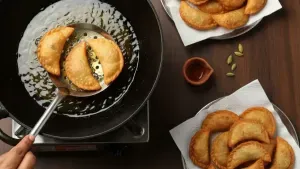 Frying golden gujiyas in oil