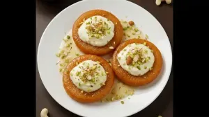 Place the malpua on a serving plate, pour thick rabri over it, garnish with dry fruits, and serve for Holi.