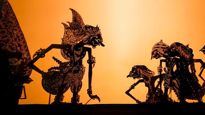 WAYANG KULIT- Ilustrasi pertunjukan wayang kulit yang merupakan bagian dari tradisi masyarakat Jawa.