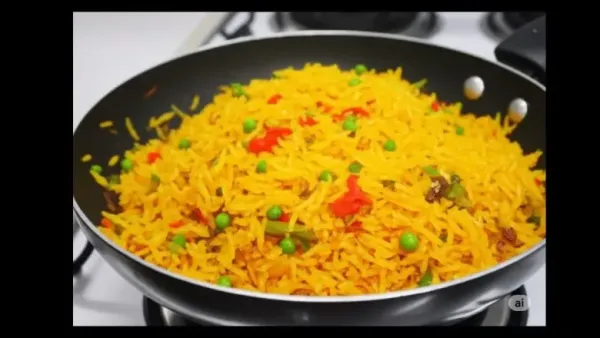 स्प्रिंग ओनियन्सने सजवलेले शेझवान फ्राईड राईसची वाफाळलेली प्लेट सर्व्ह करण्यासाठी तयार आहे.