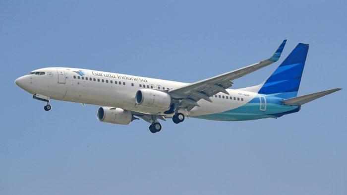 Ilustrasi pesawat Garuda Indonesia yang sedang mengudara.