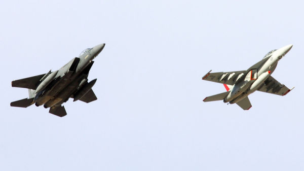 F-15E Strike Eagle and F/A-18 Super Hornet in flight