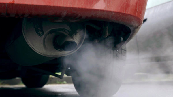 A car's muffler pumping out exhaust.