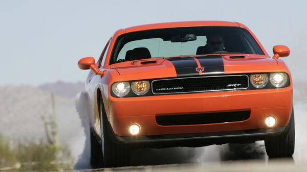 2008 Dodge Challenger SRT8 doing a burnout on desert road, front-view