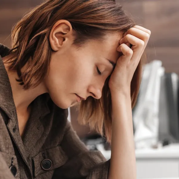 Woman speaking away the pain of a headache with intention