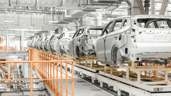 Cars on assembly line in plant