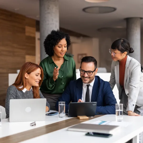 group of employees working together in office sharing office perks