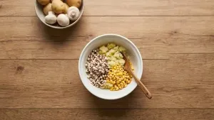 Mix mashed boiled potatoes, finely chopped mushrooms and lightly crushed corn together in a large bowl.