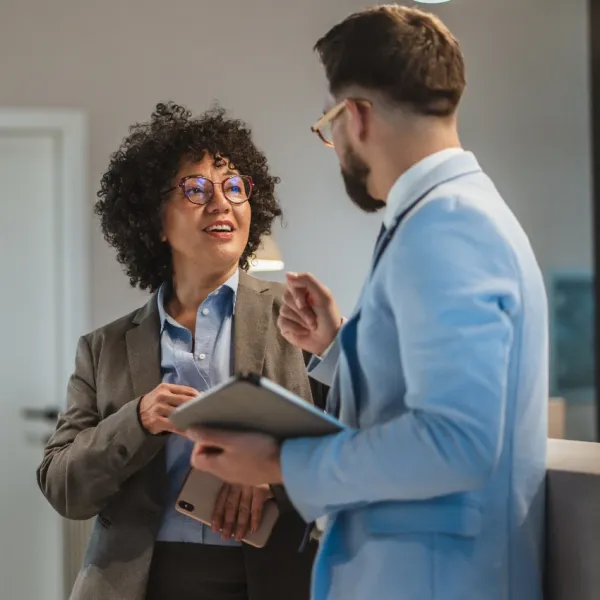 female worker asking coworker for help
