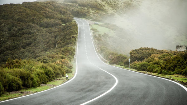 A hilly road in the countryside on a foggy day