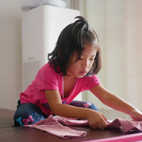 girl folding clothes forced to do chores teaches her to have a strong work ethic