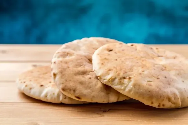 Pita, Arabic bread, soft baked flatbreads on wooden background, selective focus