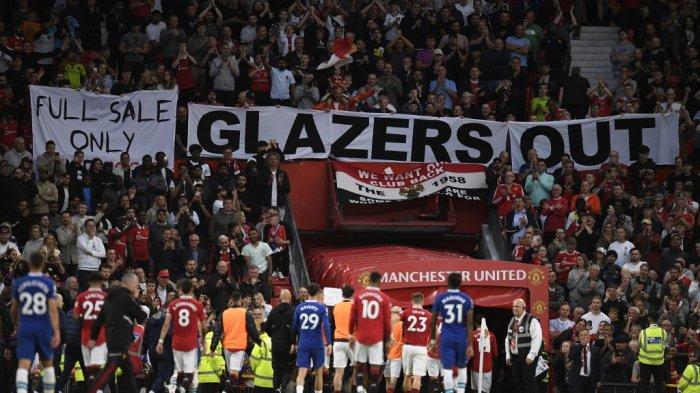 Fans Manchester United memasang spanduk dengan pesan protes terhadap pemilik Glazers saat para pemain meninggalkan lapangan pada babak pertama pertandingan sepak bola Liga Utama Inggris antara Manchester United dan Chelsea di Old Trafford di Manchester, barat laut Inggris, pada 25 Mei 2023.Oli SCARFF/AFP
