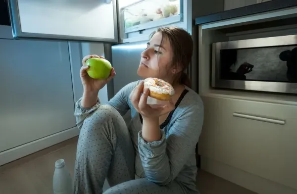 54321341 Teenage girls sitting in a bedroom eating popcorn