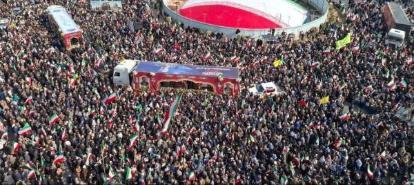 Mourners wave Iranian flags during funeral of IRGC Navy chief Alireza Tangsiri, killed in Israeli strikes in late March.