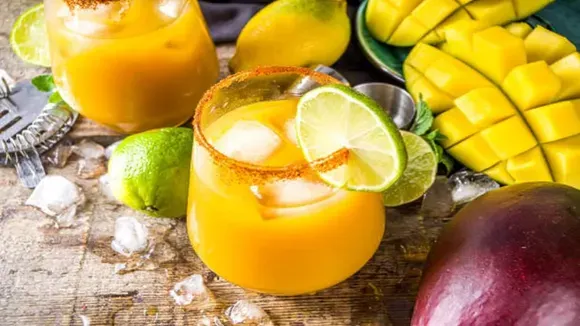 Glass of mango chili lemonade garnished with lime slices