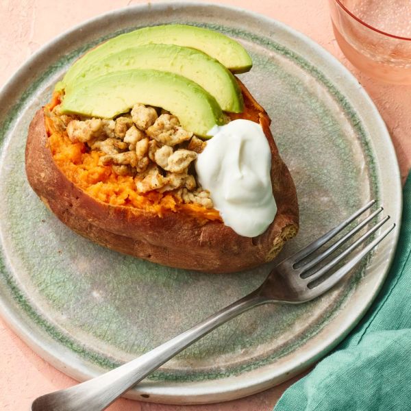 A recipe image of Sweet Potatoes Stuffed with Ground Turkey & Avocado. Credit: Photographer: Greg Dupree, Prop Stylist: Claire Spollen, Food Stylist: Chelsea Zimmer