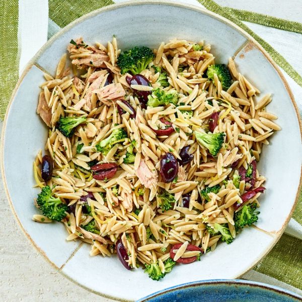 A dish of orzo pasta mixed with tuna broccoli and olives in a bowl Credit: Leigh Beisch