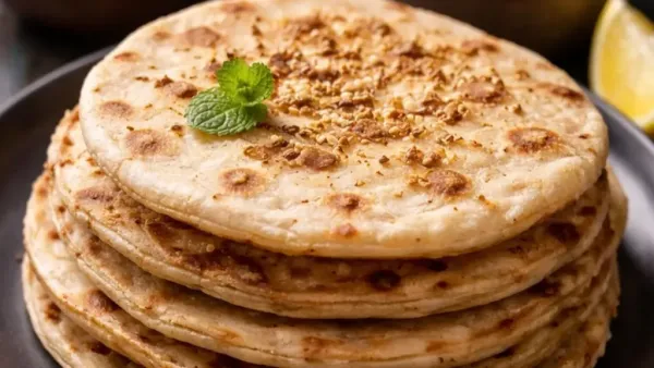 Sattu and mint stuffed roti, pan-cooked until golden brown and lightly brushed with ghee.