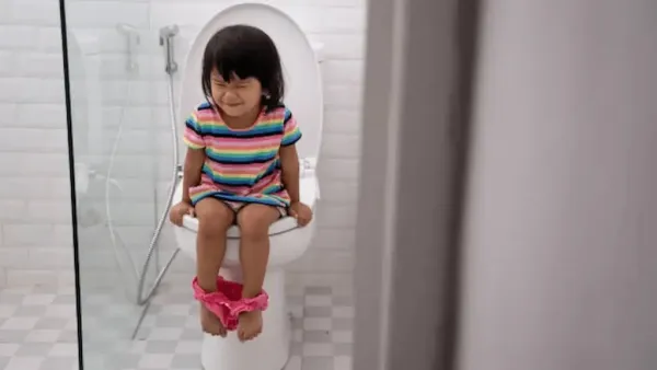 Why does the child go to the toilet again and again